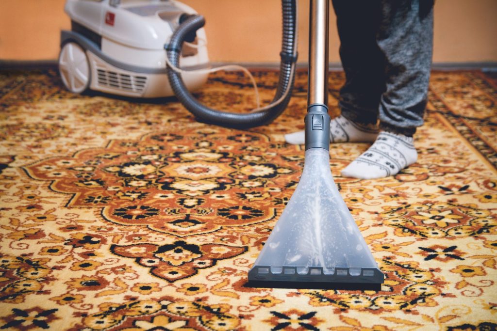 Cleaning wand on a detailed Persian-style rug